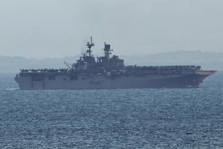 The USS Tripoli (LHA-7) amphibious assault ship enters the Singapore Straits, amid the U.S.-Israeli conflict with Iran, as seen from Singapore, March 17, 2026. REUTERS/Edgar Su