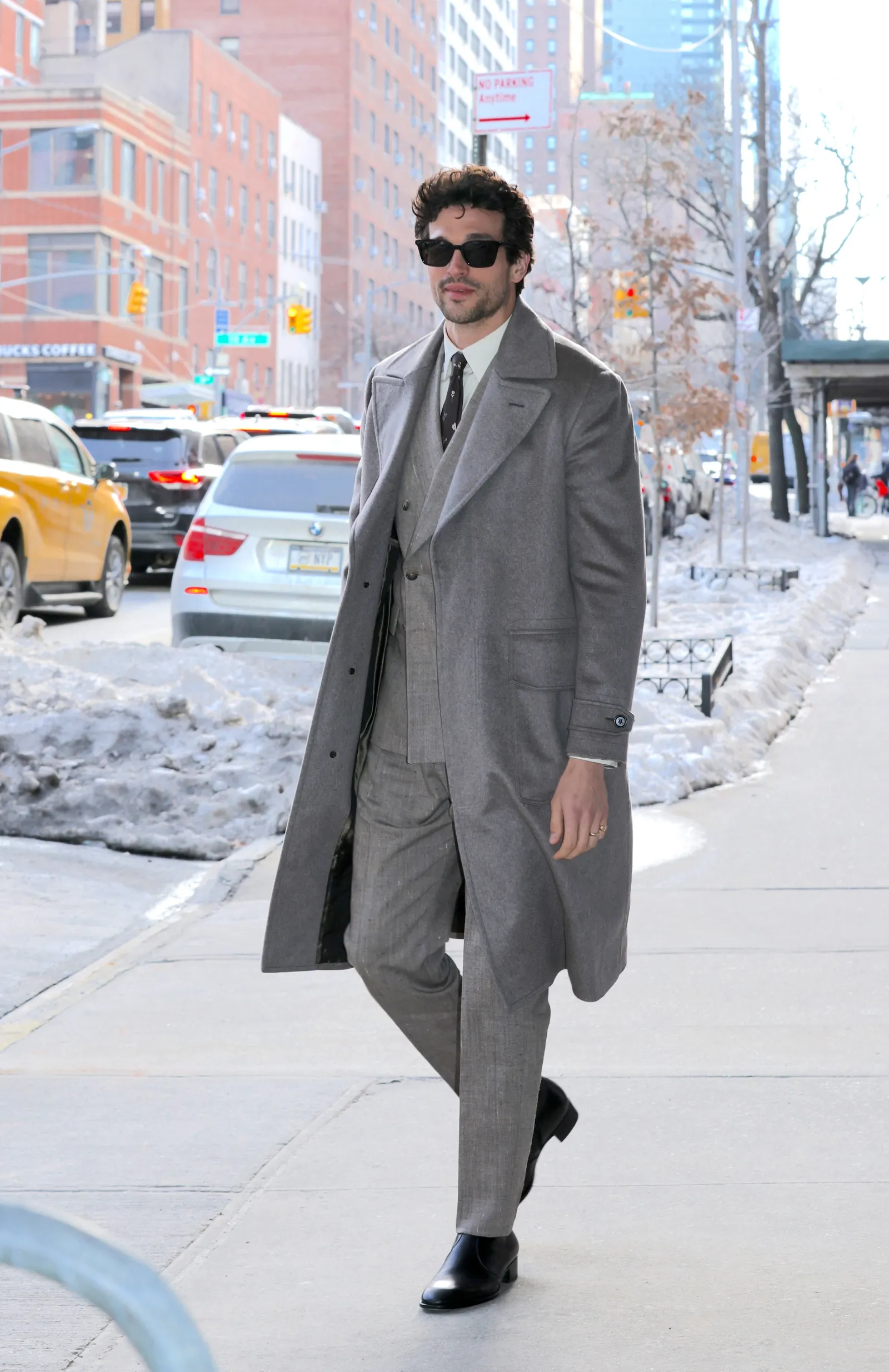 Image may contain Clothing Coat Formal Wear Suit Blazer Jacket City Overcoat Car Transportation and Vehicle