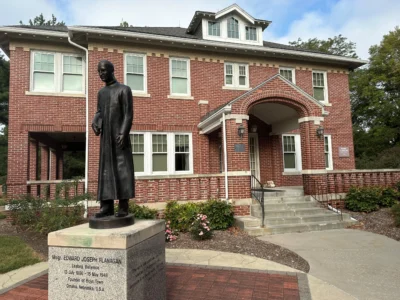 A statue of Father Edward Flanagan is seen outside the home where he lived in Boys Town, Neb., on Sept. 14, 2024. (Credit: Peter Smith/AP.)