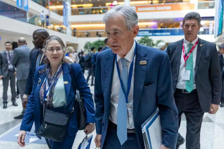 US Federal Reserve Chair Jerome Powell and others seen walking