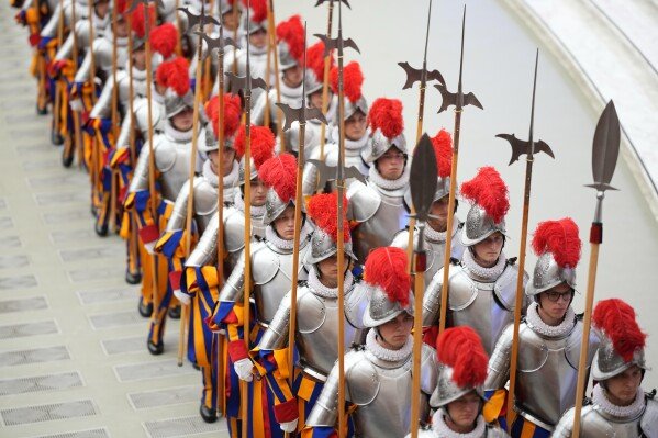 Cadets arrive at the swearing in ceremony for 28 new Pontifical Swiss Guards in the Paul VI Hall at the Vatican, Wednesday, May 6, 2026. (AP Photo/Andrew Medichini)