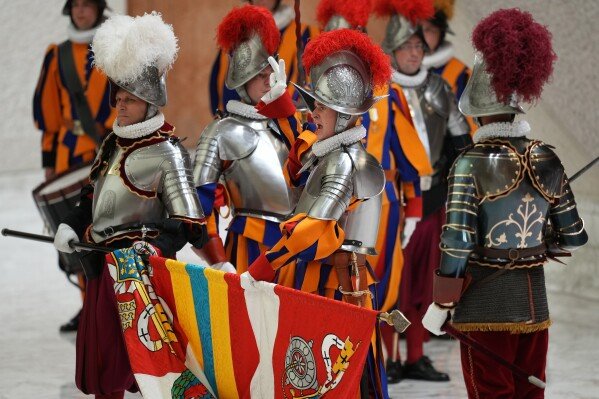 A cadet recites the oath during the swearing in ceremony for 28 new Pontifical Swiss Guards in the Paul VI Hall at the Vatican, Wednesday, May 6, 2026. (AP Photo/Andrew Medichini)