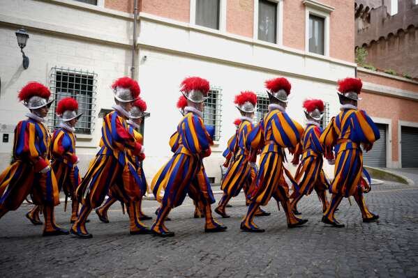 Pontifical Swiss Guards march ahead of a swearing in ceremony, at the Vatican, Wednesday, May 6, 2026. (AP Photo/Andrew Medichini)
