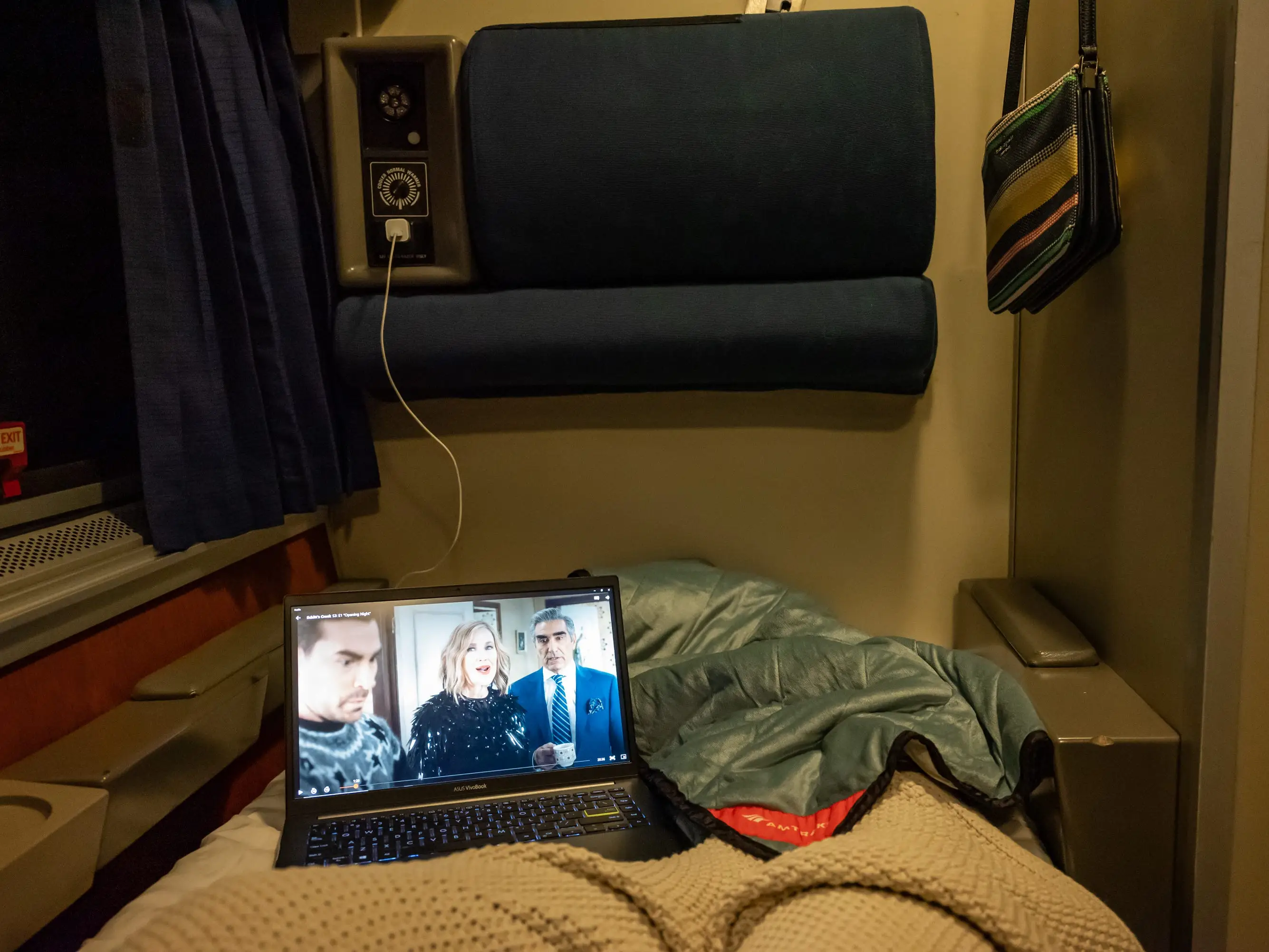 POV of the writer in bed watching TV on her laptop