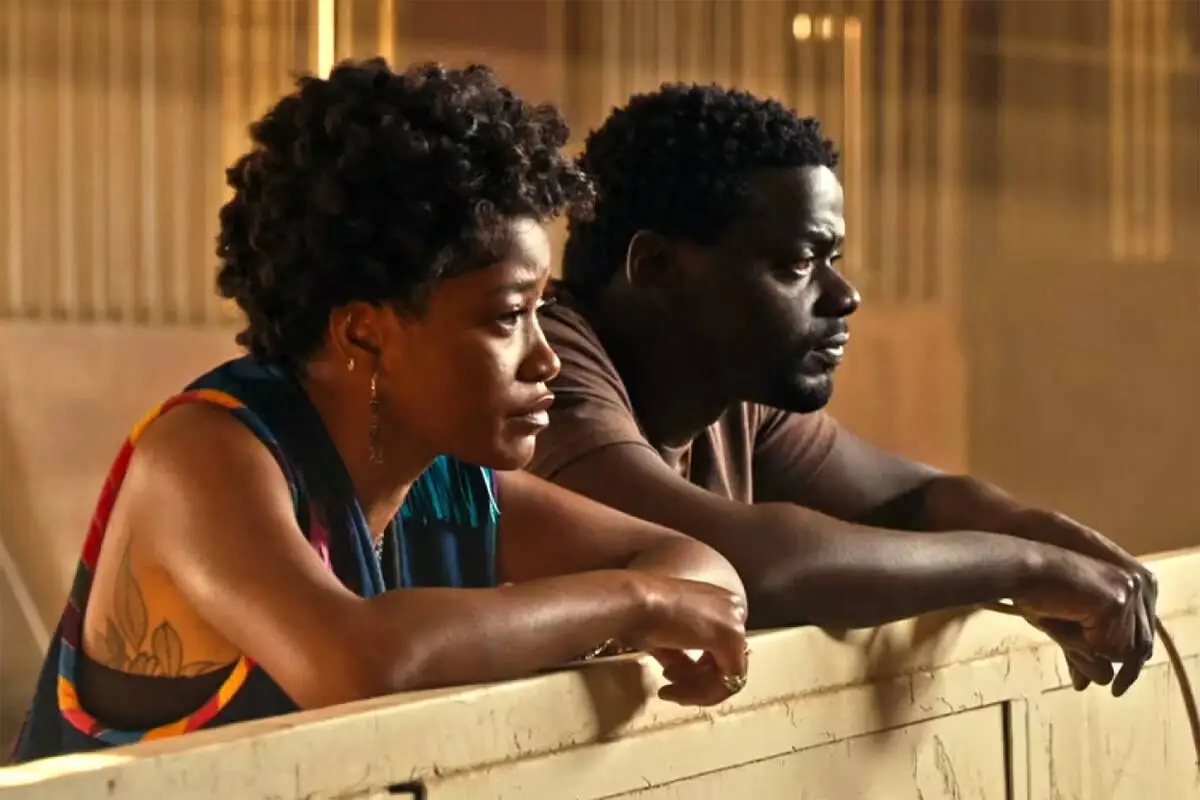 Keke Palmer and Daniel Kaluuya leaning on a fence post in Nope movie