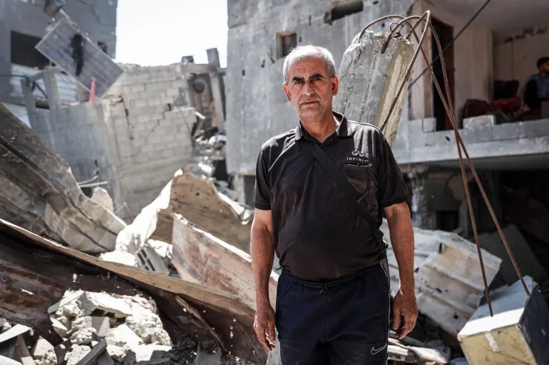 Imad Khroub lost his home after an Israeli strike targeted the residential block where he lived in Gaza City’s Shati refugee camp, following an evacuation order issued only minutes before the attack [Abdelhakim Abu Riash/ Al Jazeera]