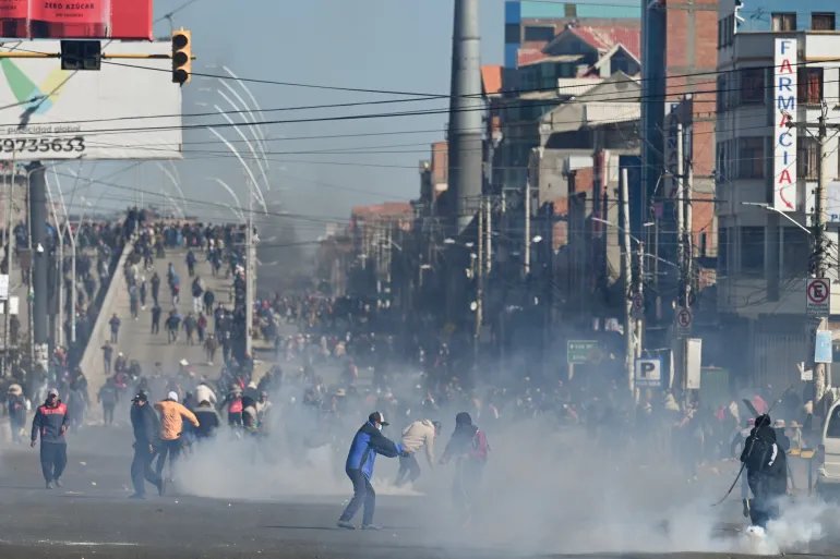 Demonstrators stand amid tear gas as they protest against President Rodrigo Paz's government amid an ongoing economic and fuel crisis in El Alto, Bolivia, May 16, 2026. [Claudia Morales]