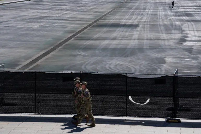 Members of the National Guard walk near fences at the drained Lincoln Memorial Reflecting Pool, following renovations and Independence Day celebrations, in Washington, D.C., U.S., July 30, 2026. REUTERS/Nathan Howard